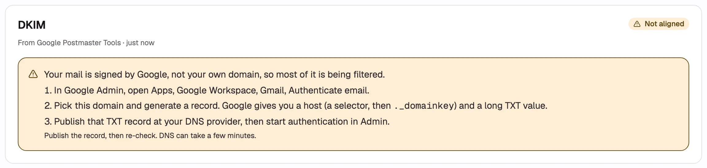 The DKIM card in the “Not aligned” state, with the amber box open showing the explanation sentence
and the three numbered Google Admin steps.