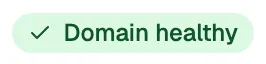 A connected accounts row for a Workspace mailbox, zoomed in on the domain health badge under the
address, with the chevron that opens the detail screen.